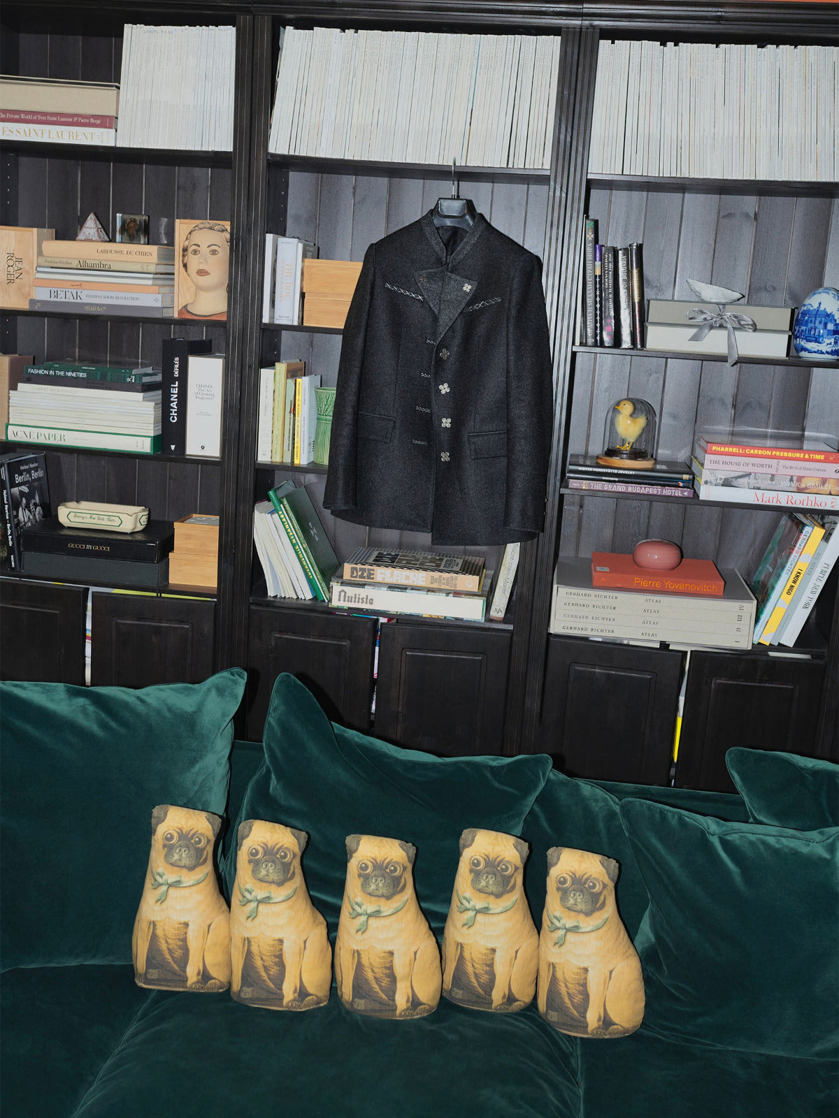 The Autista Club 17 Jacket featuring 17 The Sigillum Blackened Sterling Silver Buttons on library in studio rue de verneuil with Wallis Simpson pug pillow on green sofa