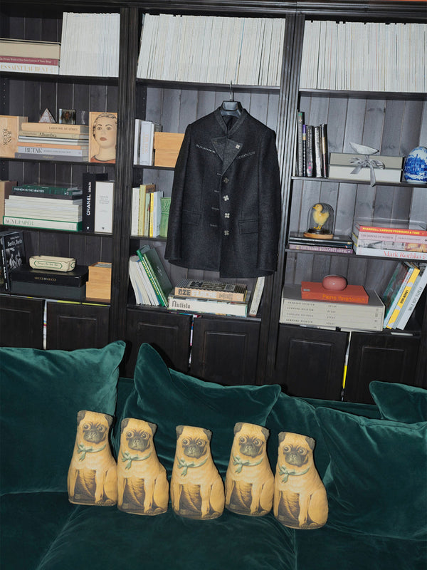 The Autista Club 17 Jacket featuring 17 The Sigillum Blackened Sterling Silver Buttons on library in studio rue de verneuil with Wallis Simpson pug pillow on green sofa